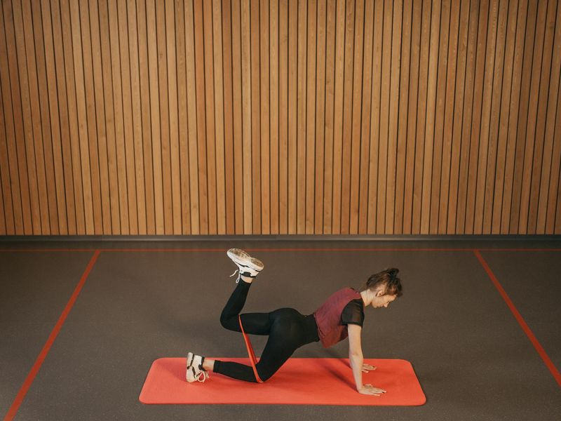 Minimalist training space with sunlight and exercise mat.